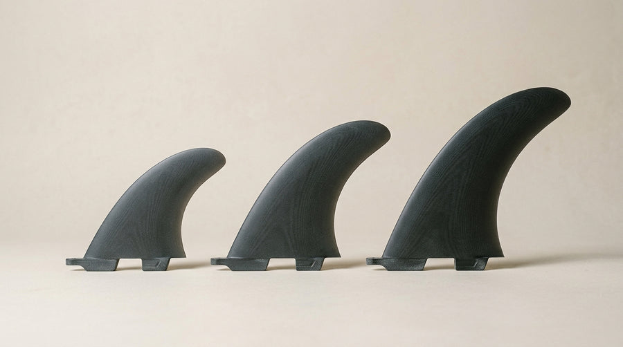 Surfboard fins in S, M and L sizes lined up