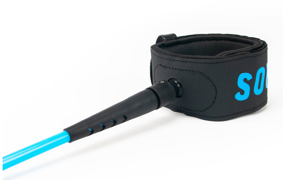 Close-up of a leash linking a surfer’s ankle to a foam board in the water